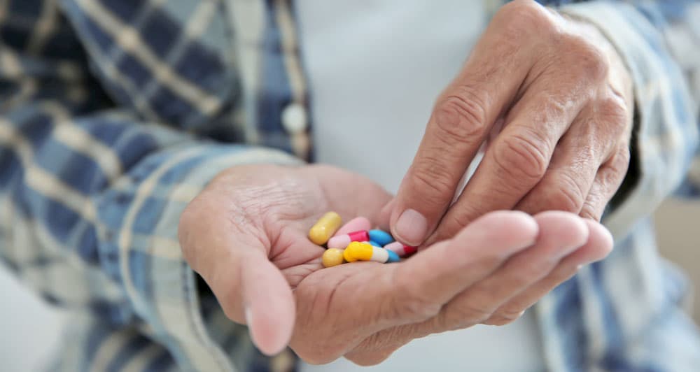 A man holding pills